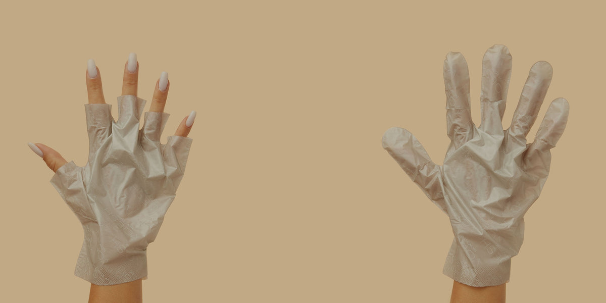 Woman wearing Collagen Gloves; showing one hand with fingertip removed