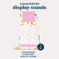 Countertop Display Stand for pedicure kits on a grey background.