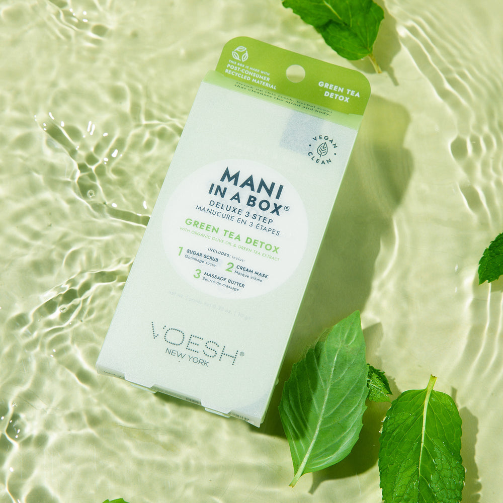 Green Tea Detox Mani in a Box with green tea leaves on green water backgroundackground