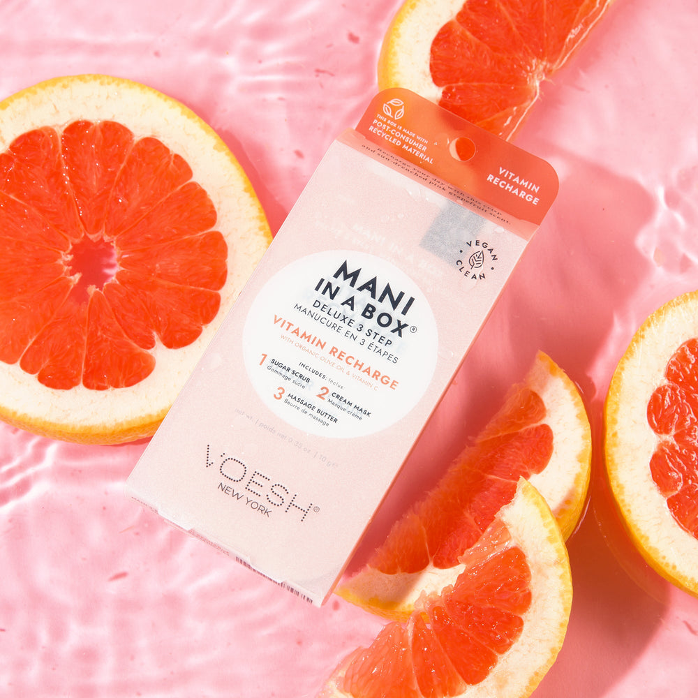 Vitamin Recharge Mani in a Box on pink background with grapefruit slices
