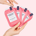 hand holding all 4 steps of Pomegranate Radiance Pedi in a Box Deluxe 4 Step