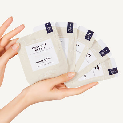 hand holding all 5 steps of the Coconut Cream Pedi in a Box O2 Fizz