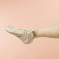 Woman wearing Collagen Socks on pink background