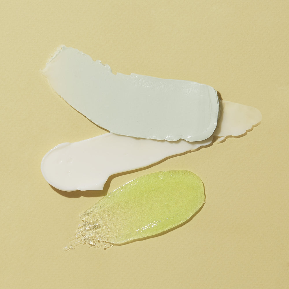 texture of scrub, mud masque, massage lotion on yellow background