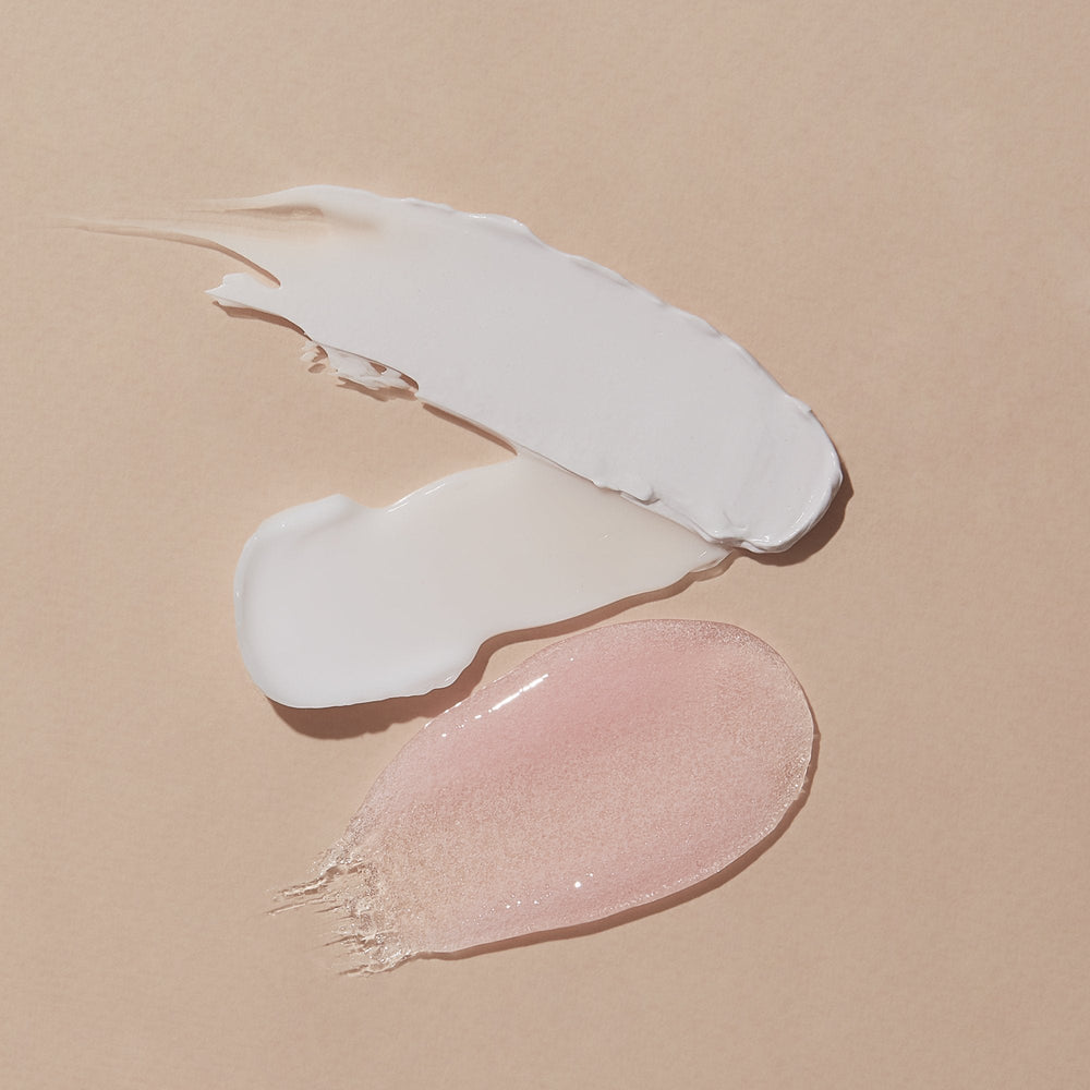 texture of scrub, mud masque, massage lotion on pink background