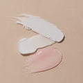 texture of scrub, mud masque, massage lotion on pink background