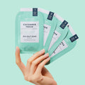 woman's hand holding cucumber fresh pedi in a box 4 step on light blue background