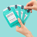 woman holding packets of pedi in a box 4 step eucalyptus energy boost on blue background