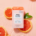 pedi in a box 4 step vitamin recharge on pink background in water with grapefruit slices