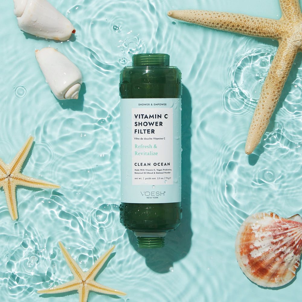 Clean Ocean Vitamin C Shower Filter in water with seashells on blue background