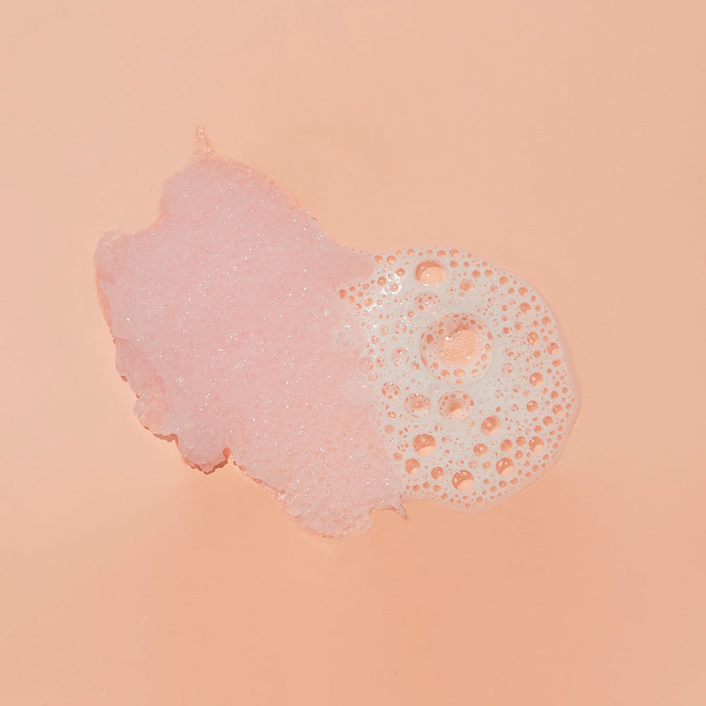 Sugar scrub texture with bubble on pink background