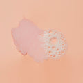 Sugar scrub texture with bubble on pink background