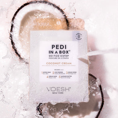 Coconut Cream Pedi in a Box O2 Fizz with water pouring on top and halved coconuts in the background