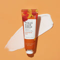 Pumpkin pie vegan hand creme with texture swatch on orange background