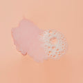 Texture of sugar scrub with bubble on pink background