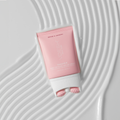 Smooth’d Body Refining Roller Crème on top of lines of creamy texture on a white background.
