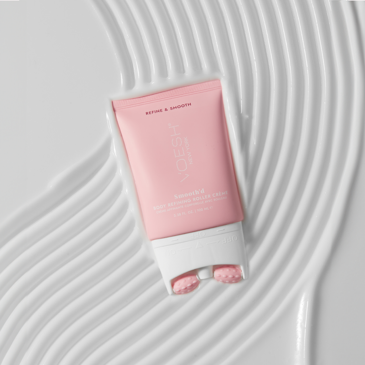 Smooth’d Body Refining Roller Crème on top of lines of creamy texture on a white background.
